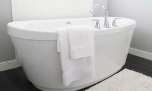A White Clean Tub, Cleaning the Bathtub to Ensure a Hygienic Environment.