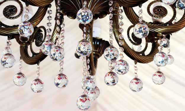 A Crystal Chandelier Hanging from Ceiling.