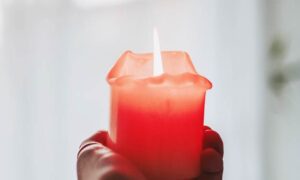 Person Holding Candle. How to Remove Candle Wax.