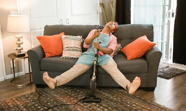 Exhausted man after deep cleaning the house.