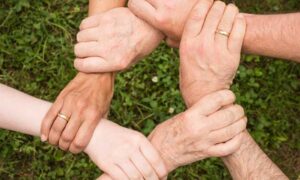 Family Hands Intertwined - Cleaning House as a Team.