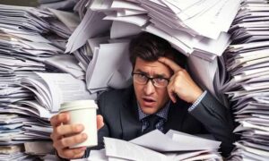 Man Buried Under a Pile of Paperwork: How to Organize Your Paperwork