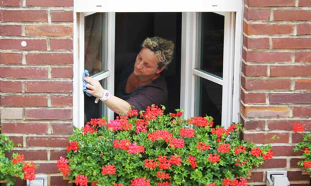 Woman Cleaning Windows from Natural Window Cleaning Recipe.