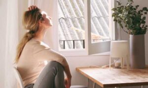 Woman sitting by the window after removing and cleaning musty odors.