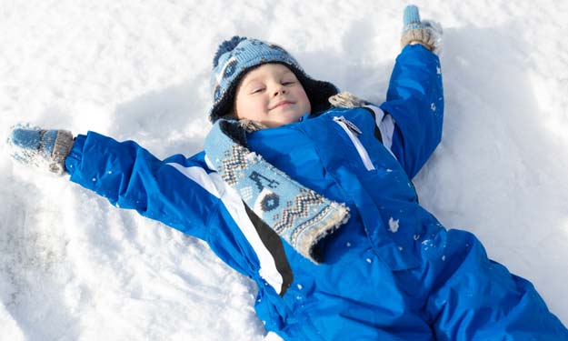 Boy Playing in Winter Snow.