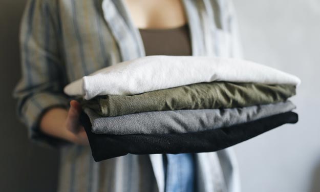 Woman Putting Clean Dry Folded Clothes Away.