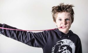 Boy with Gum in his mouth and How to Remove Gum from Carpet.